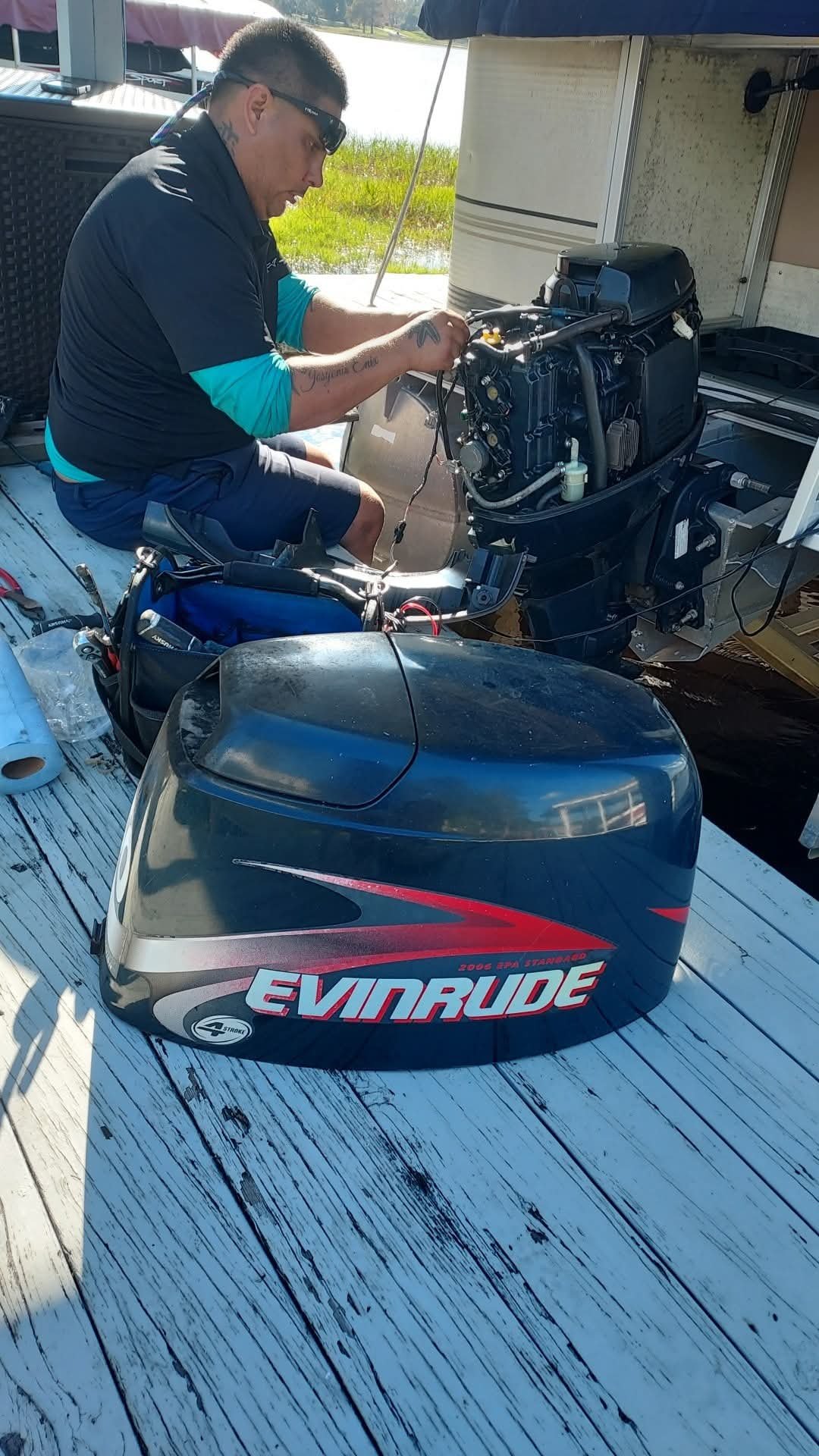 Evinrude outboard with cowling removed for dockside repair