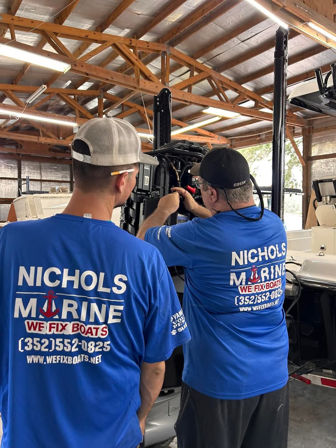 Nichols Mobile Marine crew servicing an outboard motor